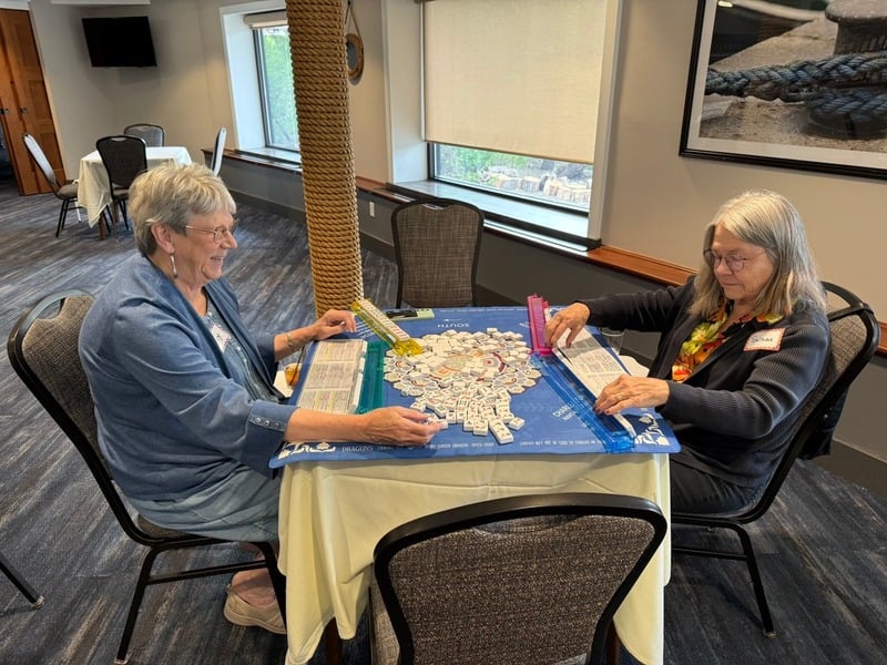 American Mah Jongg tiles laid out on a table with NMJL cards