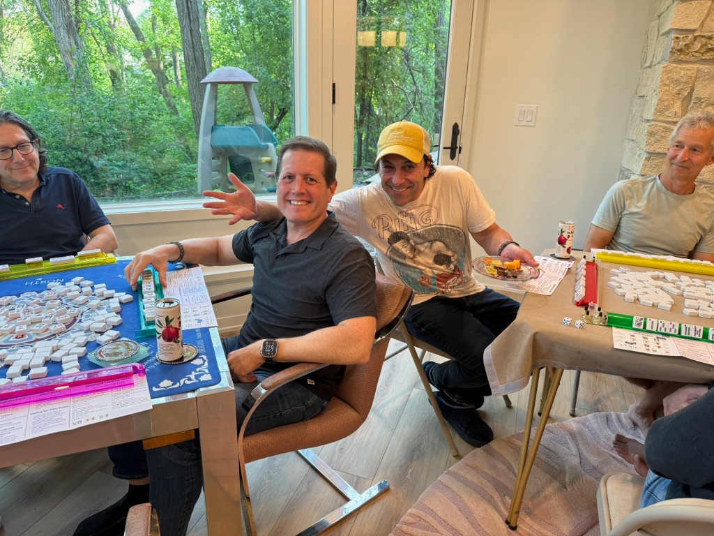 A group of friends playing Mah Jongg together at home